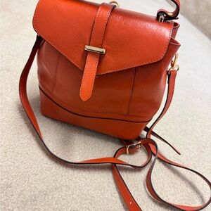 Orange Leather Backpack with Structured Design and Adjustable Straps